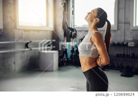 Focused fitness training a woman stretching in a modern, wellequipped gym environment setting 120699024