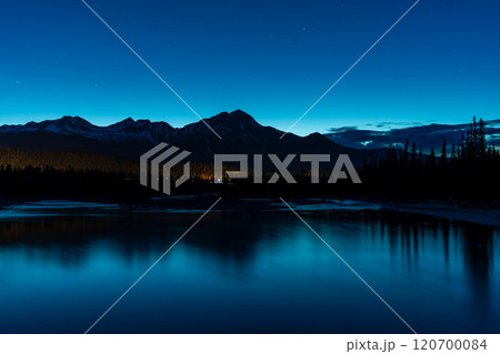 Pyramid Mountain silhouette reflected on Athabasca River at twilight time. Town Jasper at night. Alberta, Canada. 120700084