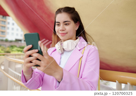 Portrait of Woman Using Smartphone Outdoors Smiling Portrait of Woman Using Smartphone Outdoors Smiling 120700325