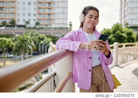 Listening Music While Walking on Bridge in Urban Area 120700373