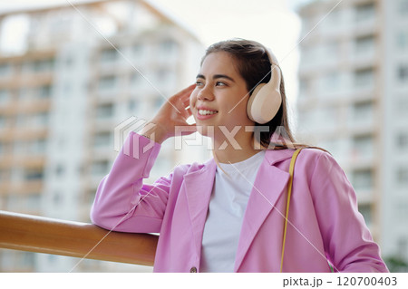 Listening to Music in Urban Setting Wearing Headphones 120700403