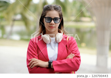 Wearing Headphones and Sunglasses in Outdoor Setting 120700443