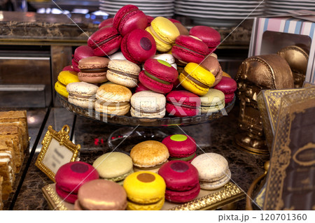Large pile of macarons in glass vase in pastry vintage expensive cafe 120701360