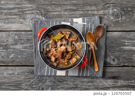 beer braised pork stew in a red pot 120703507