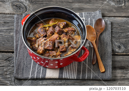 beer braised pork stew in a red pot beer braised pork stew in a red pot 120703510
