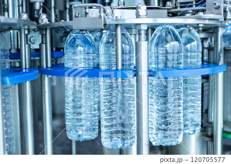 Drink water plant. Robotic of water bottles production line in factory. Process of filling water into plastic bottles to bring out to consumers. Drink water plant. Robotic of water bottles production line in factory. Process of filling water into plastic bottles to bring out to consumers. 120705577