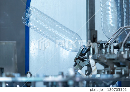 Drink water plant. Robotic of water bottles production line in factory. Process of filling water into plastic bottles to bring out to consumers. 120705591