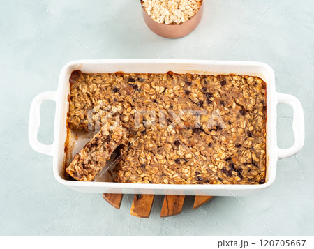 Vegan oatmeal banana cake in white baking pan on turquoise 120705667
