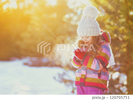 Winter happy smiling little girl child over sunny snowy background 120705751
