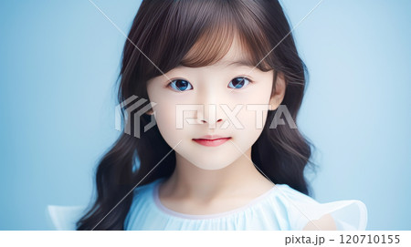 Portrait of smiling asian girl child with long white hair blue background. Portrait of smiling asian girl child with long white hair blue background. 120710155