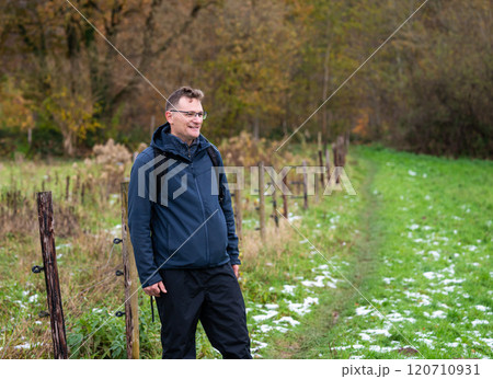 Outdoor portrait of a 45 yo white hiking man in an autumn forest in Oud Heverlee, Belgium 120710931