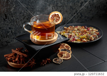 Cup of herbal tea with ingredients and slices of dried orange slices. 120711632