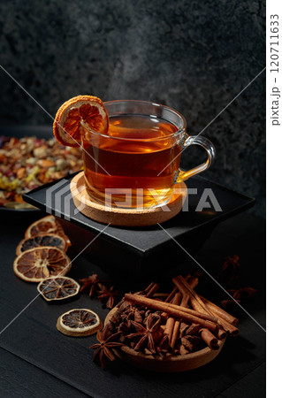 Cup of herbal tea with ingredients and slices of dried orange slices. Cup of herbal tea with ingredients and slices of dried orange slices. 120711633