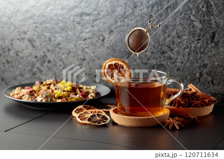 Cup of herbal tea with ingredients and slices of dried orange slices. Cup of herbal tea with ingredients and slices of dried orange slices. 120711634