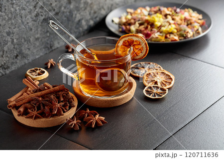 Cup of herbal tea with ingredients and slices of dried orange slices. Cup of herbal tea with ingredients and slices of dried orange slices. 120711636