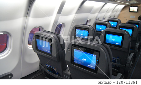 Above the Clouds, December 10, 2015: View from an Economy Class Seat with In-Flight Entertainment Screens on a Long-Haul Flight 120711861