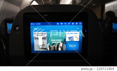 Above the Clouds, December 10, 2015: View from an Economy Class Seat with In-Flight Entertainment Screens on a Long-Haul Flight 120711864