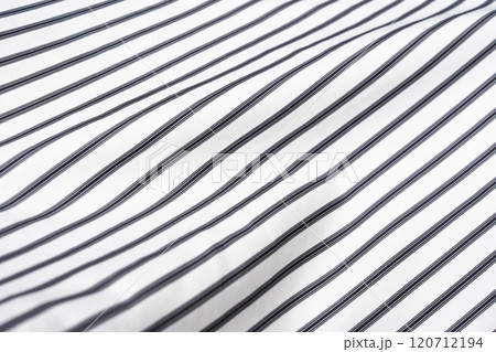 Fabric with alternating black and white stripes displayed on a smooth surface Fabric with alternating black and white stripes displayed on a smooth surface 120712194