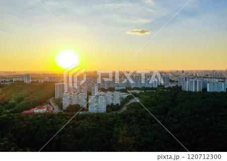 Stunning sunset over a vibrant urban skyline surrounded by lush greenery Stunning sunset over a vibrant urban skyline surrounded by lush greenery 120712300