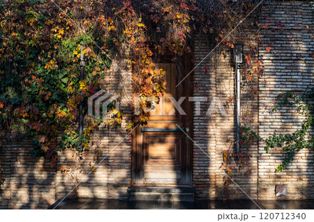 Charming autumn colors entwine a rustic door in Tbilisi, Georgias vibrant streetscape Charming autumn colors entwine a rustic door in Tbilisi, Georgias vibrant streetscape 120712340