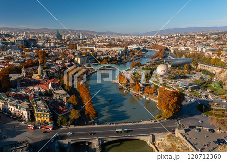 Vibrant autumn colors embracing the Tbilisi skyline with river views and cultural landmarks in Georgia 120712360