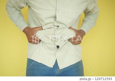 man's hand holding excessive belly fat, overweight concept 120712593