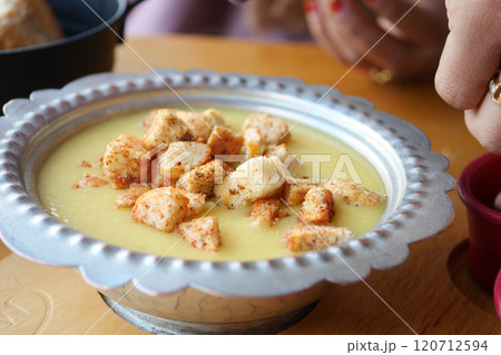 Delicious Creamy Soup With Croutons In Metal Bowl On Wooden Table Delicious Creamy Soup With Croutons In Metal Bowl On Wooden Table 120712594
