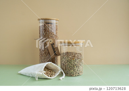Raw buckwheat porridge and green lentil in sustainable natural packaging. Refillable systems. Gluten free cereals. Health gut benefits. Concept of alternative whole spelt grain ingredient. Vegetarian 120713628