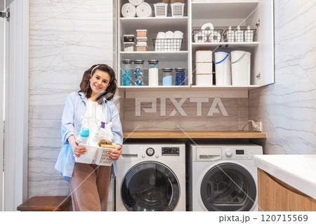 Woman housewife posing at modern white wooden bathroom laundry storage minimalism organizing 120715569