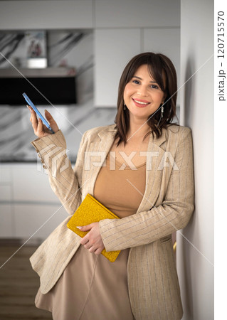Portrait smiling business woman kitchen interior designer posing with notepad stack closeup 120715570