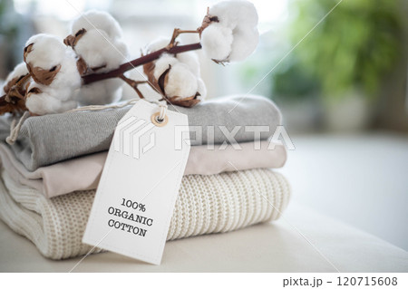 A neat stack of knitted clothing labeled 100 percent organic cotton. White background. A neat stack of knitted clothing labeled 100 percent organic cotton. White background. 120715608