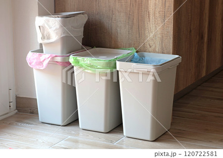 Separate sorting of garbage at home. Colorful bags and containers. Ecology and safe waste.  120722581