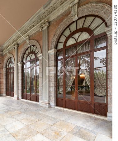 Ornate arched doorway leads into Beykoz Mecidiye Pavilion, featuring wooden and glass doors with intricate carvings 120724380