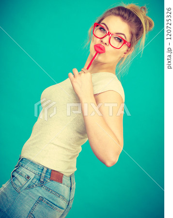 Happy woman holding fake lips on stick 120725326