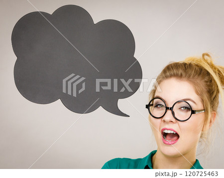 Woman holding black thinking bubble Woman holding black thinking bubble 120725463