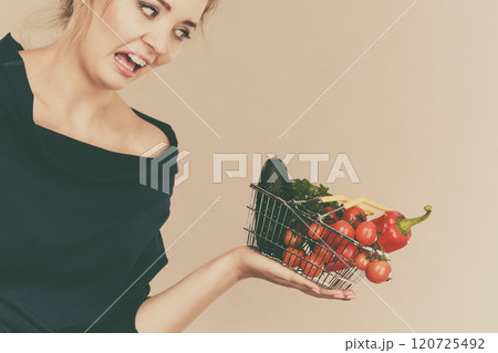 Woman with vegetables, negative face expression 120725492