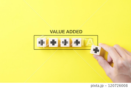 Value add concept. Hand place wooden cube with plus sign on yellow background. Positive thinking or personal growth and development. download style which means value added. value add for business. Value add concept. Hand place wooden cube with plus sign on yellow background. Positive thinking or personal growth and development. download style which means value added. value add for business. 120726008