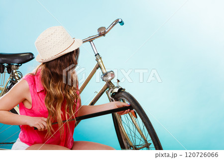 Woman pumping up tire tyre with bike pump. Woman pumping up tire tyre with bike pump. 120726066