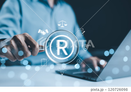 Registered trademark, intellectual property concept. Businessman working on laptop with digital icons register trademarks, copyright, patent, intellectual property law, legal protection in business. Registered trademark, intellectual property concept. Businessman working on laptop with digital icons register trademarks, copyright, patent, intellectual property law, legal protection in business. 120726098