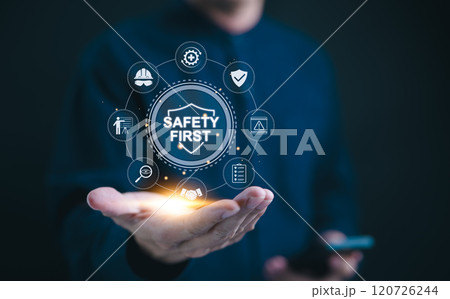 Safety first concept. Work safety compliance, A professional holds digital "Safety First" with icons that symbolize work safety, compliance, and protective measures. protection, workplace regulations, 120726244