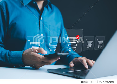 Shopping online and e-commerce technology concept. A person using smartphone and laptop, with several digital shopping cart icons displayed, represents online shopping and e-commerce. shop on internet Shopping online and e-commerce technology concept. A person using smartphone and laptop, with several digital shopping cart icons displayed, represents online shopping and e-commerce. shop on internet 120726266