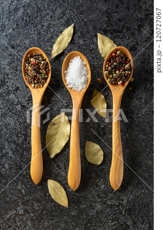 Mix of organic dried spices in wooden spoons. 120727067