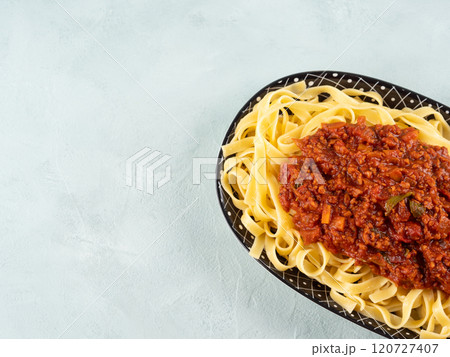 Tagliatelle with vegan tomato bolognese ragu with soya protein granules Tagliatelle with vegan tomato bolognese ragu with soya protein granules 120727407