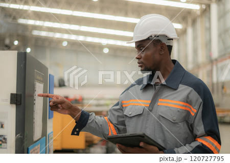 Worker using technology in an industrial setting. 120727795