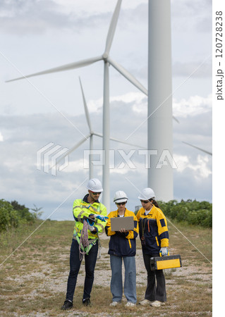 Engineer wearing safety uniform using laptop discussed plan about renewable energy at station energy power wind turbine. technology protect environment reduce global warming problems. Engineer wearing safety uniform using laptop discussed plan about renewable energy at station energy power wind turbine. technology protect environment reduce global warming problems. 120728238