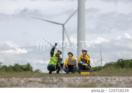 Engineer wearing safety uniform using laptop discussed plan about renewable energy at station energy power wind turbine. technology protect environment reduce global warming problems. Engineer wearing safety uniform using laptop discussed plan about renewable energy at station energy power wind turbine. technology protect environment reduce global warming problems. 120728239