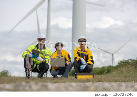 Engineer wearing safety uniform using laptop discussed plan about renewable energy at station energy power wind turbine. technology protect environment reduce global warming problems. Engineer wearing safety uniform using laptop discussed plan about renewable energy at station energy power wind turbine. technology protect environment reduce global warming problems. 120728240