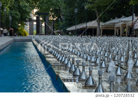 Elegant water fountains sparkle in Yerevans serene alley as evening descends on the vibrant city 120728532