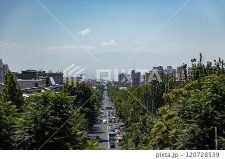 Vibrant cityscape showcasing the lively streets of Yerevan against a backdrop of distant mountains 120728539