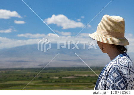Captivating views of Ararat Mountain in Armenia with a serene figure enjoying the landscape 120728565